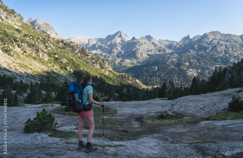 Obraz premium Female hiker on the famous Haute Randonnée Pyrénéenne trail in France.