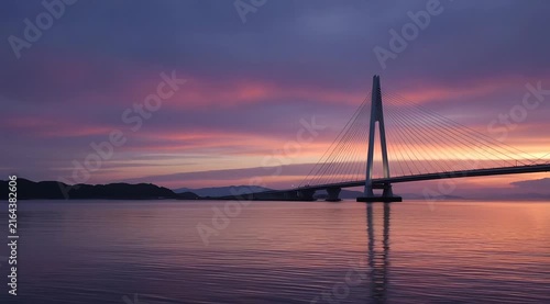 Stunning Urban Bridge Silhouette Reflecting in Calm Water During Vibrant Sunset