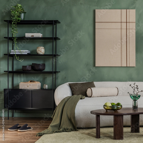 Modern living room interior with white sofa, black shelf, green wall, and minimalist abstract art canvas for home decor and design project