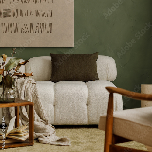 Modern cozy living room interior with white boucle sofa, green accent wall, wooden furniture, and minimalist art decor for stylish home design