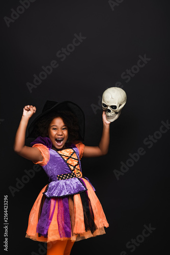 фотографія Little girl in Halloween costume joyfully celebrating spooky season