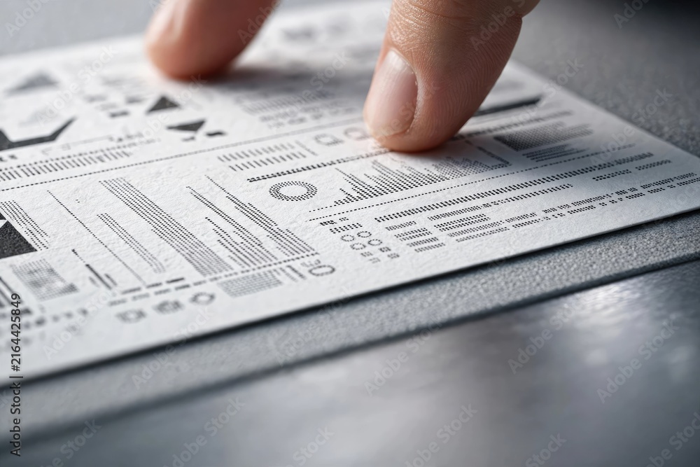 Obraz premium Hand Reviewing Financial Document or Contract Details