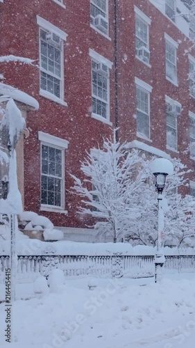 New York City during a winter blizzard. Row of 19th century townhouses in Greenwhich Village Washington Square Park, Manhattan, under heavy snowfall