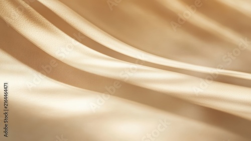 Abstract beige silk fabric background with soft waves and elegant light shadows