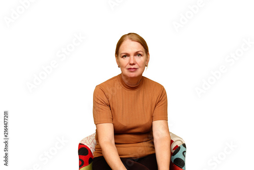 Mature woman sitting in an armchair wearing a brown top as a portrait concept on a transparent PNG background.  psychological consultation banners