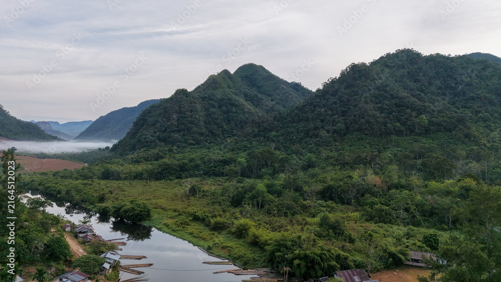 Fototapeta premium Aerial close-up of green forested mountain ridges