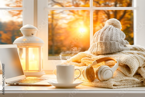 Warm drinks and cozy moments indoors during sunset in autumn