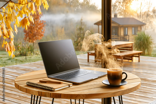 Morning work setup with laptop and coffee in a garden during autumn