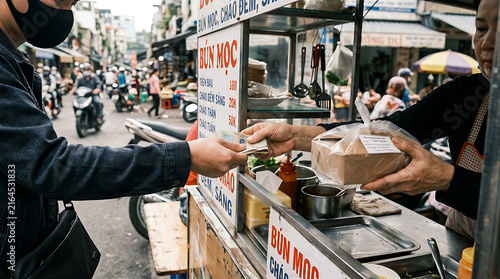 Faceless customer buying street food from a vendor in a bustling Asian market