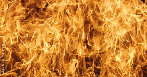 Abstract orange flames with smoke on black background.