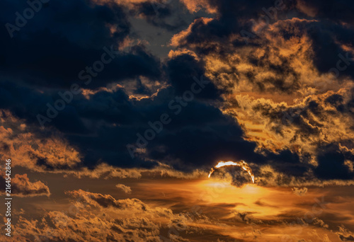 Partial solar eclipse behind dramatic clouds in Saulkrasti, Latvia