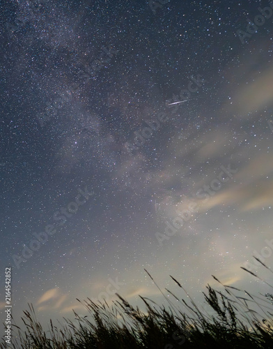 Perseid meteor crossing the Milky Way over rural Latvia
