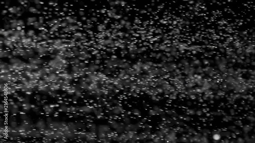 Floating abstract particle bokeh on dark background. Shot on super slow motion camera 1000 fps.