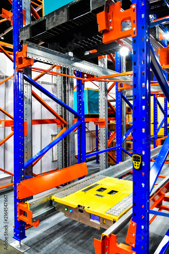 Automated pallet shuttle system running on steel racks in modern smart warehouse facility