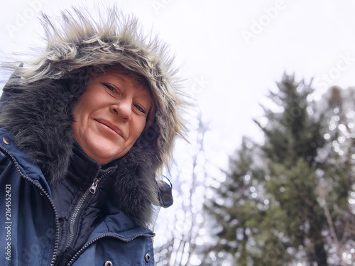 Photography Adult woman enjoys daily life in nature while taking a selfie during a chilly da