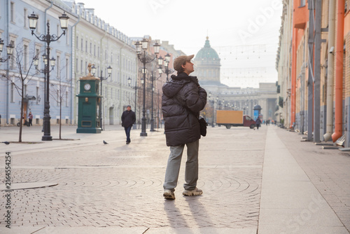 Quadro su tela Young man student sightseeing on pedestrian street in central Saint Petersburg with Kazan cathedral in background