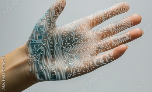 Hand with digital circuitry and smartphone, symbolizing the integration of technology 