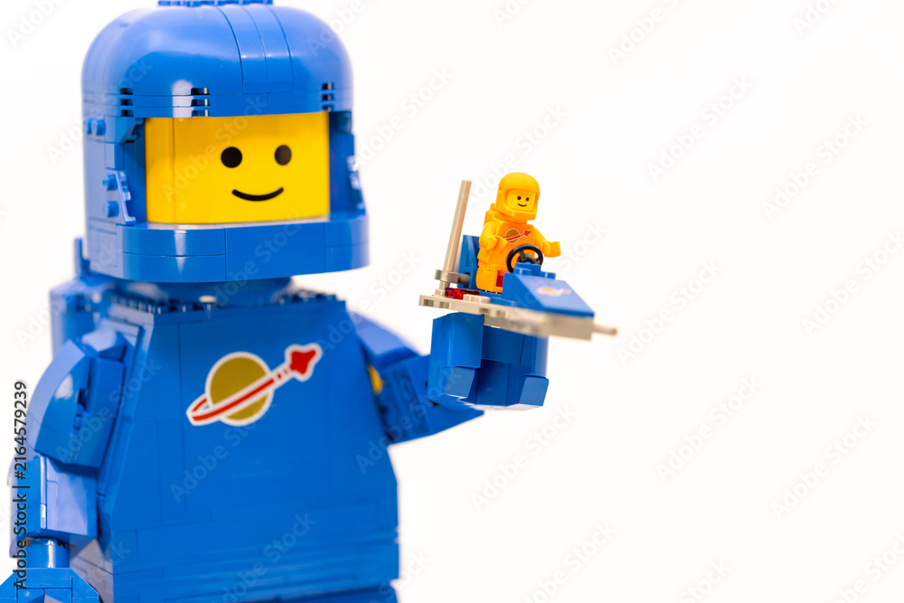 Fototapeta premium Hong Kong, June 8, 2026: A giant blue spaceman holds a tiny spacecraft, symbolizing future discovery and space exploration plans.