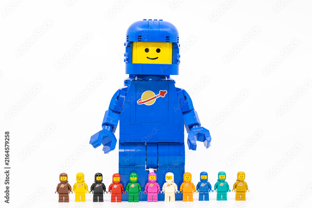 Fototapeta premium Hong Kong, June 8, 2026: A giant spaceman stands behind a lineup of eleven classic space minifigures.
