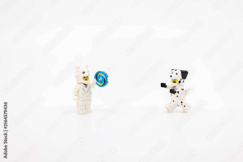 Naklejka premium Hong Kong, June 8, 2026: minifigures dressed as a cat and dalmatian dog play together with a toy ring.