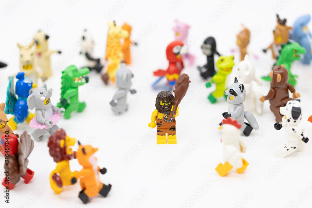 Fototapeta premium Hong Kong, June 8, 2026: A caveman holding a club stands confidently amidst a large group of diverse animal suit minifigures.