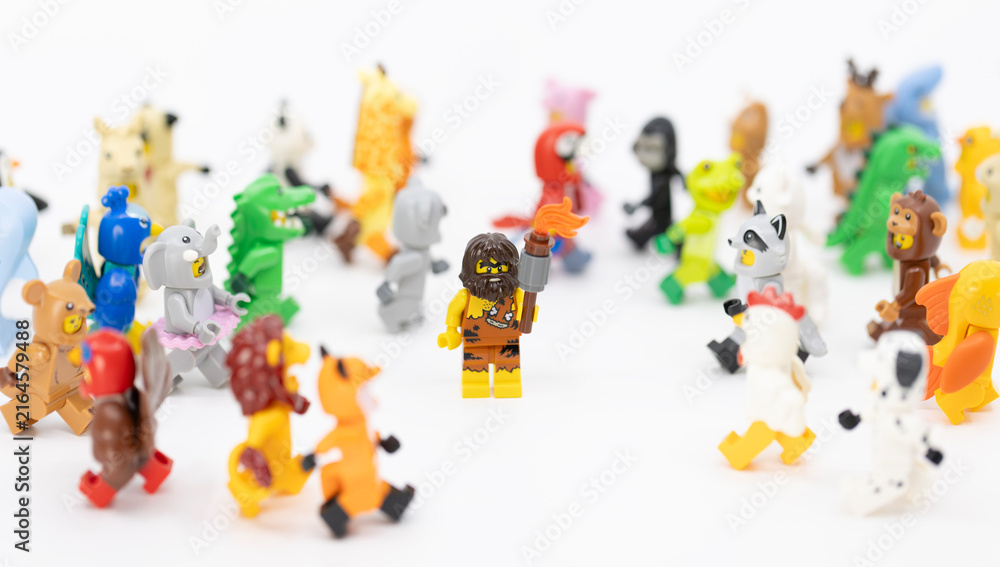 Fototapeta premium Hong Kong, June 8, 2026: A caveman holding a club stands confidently amidst a large group of diverse animal suit minifigures.