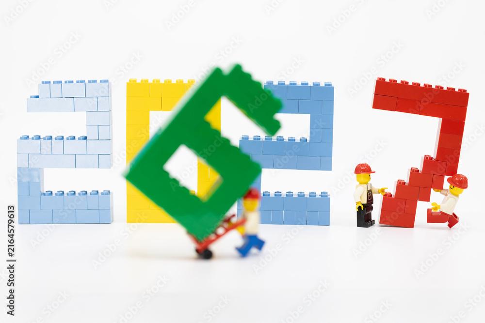 Fototapeta premium Hong Kong, August 20, 2026: A worker carries the final digit seven, symbolizing the start of 2027 and a new era.