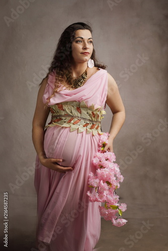Beautiful Pregnant Woman as Greek Goddess with Pink Blossoms