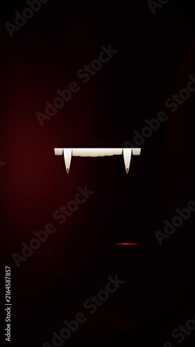 Dramatic slow-motion shot of a blood drop falling next to vampire fangs on red velvet