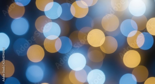 Abstract background with glowing blue and gold bokeh lights
