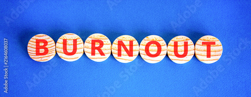 Burnout word symbol. Concept word Burnout on beautiful wooden circles. Beautiful blue background. Business medical burnout word concept. Copy space.