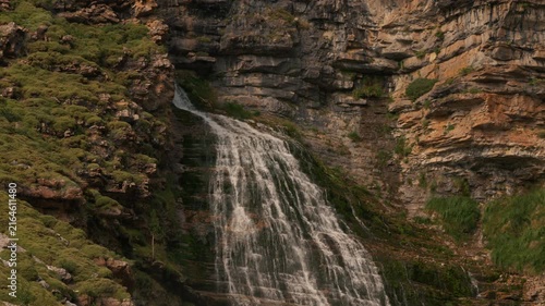 Mountain cascade flowing through rocky cliffs near Mont Perdu range, Aragon