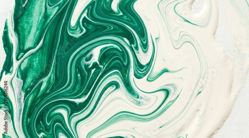 Abstract green and white paint swirl mixing together