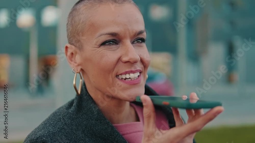 Confident Woman Records Voice Message on Smartphone
