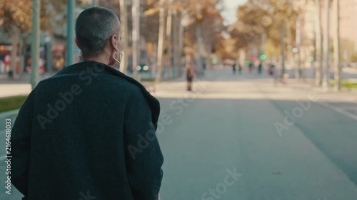 Modern Woman Walks on an Urban Street in Autumn