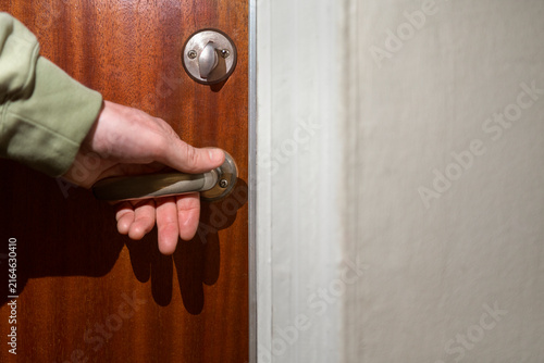 Close-up of man opening door at home