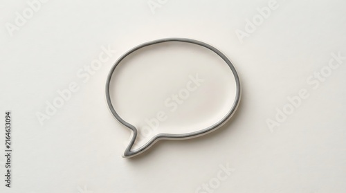 Minimalist ceramic speech bubble dish on a light gray background offering a modern aesthetic for communication and conversation concepts
