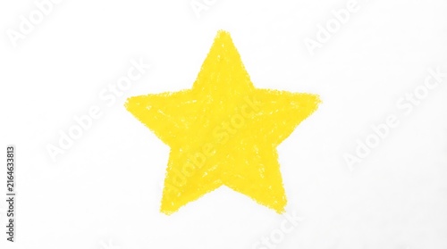 Bright yellow crayon drawing of a five pointed star on a white surface childlike art and simple illustration
