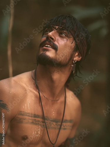 Man Looking Upward with Dark Hair and Tattoos