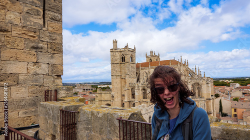 Happy Woman Tourist Above Narbonne Cathedral In France