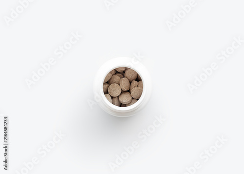 Bottle of Nutritional Supplements on White Surface