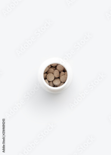 Bottle of Nutritional Supplements on White Surface