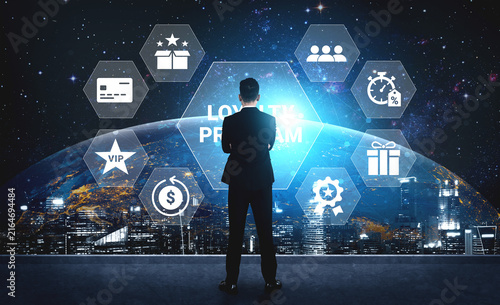 Obraz na płótnie A businessman stands against a futuristic cityscape, envisioning a loyalty program supported by advanced technology, highlighting the potential for growth and customer engagement