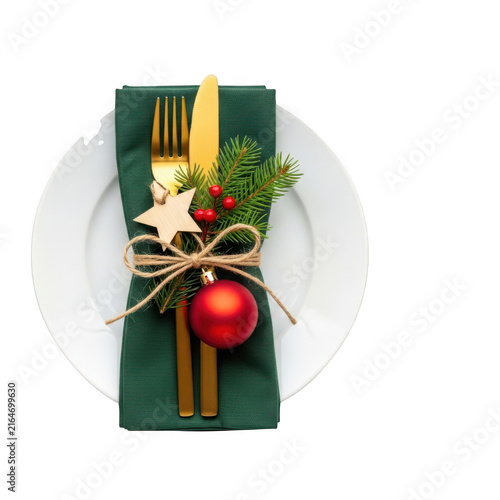 Red apple wrapped in green ribbon with utensils