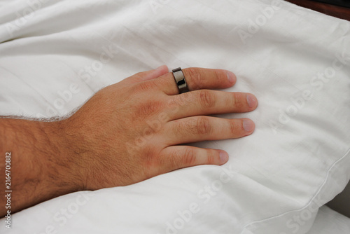 Naklejka Sleeping with a smart ring. Smart ring on a finger. Smart ring