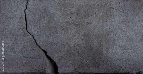 Gray abstract cracked concrete wall texture.