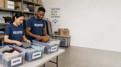 Community volunteers packing clothes in warehouse with copy space