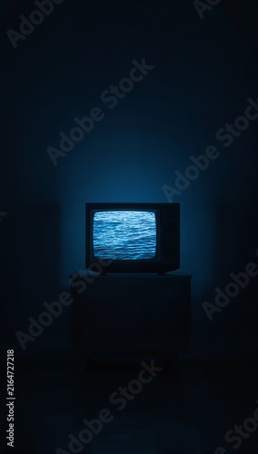 Generative AI depicts a dark room with a vintage TV displaying static