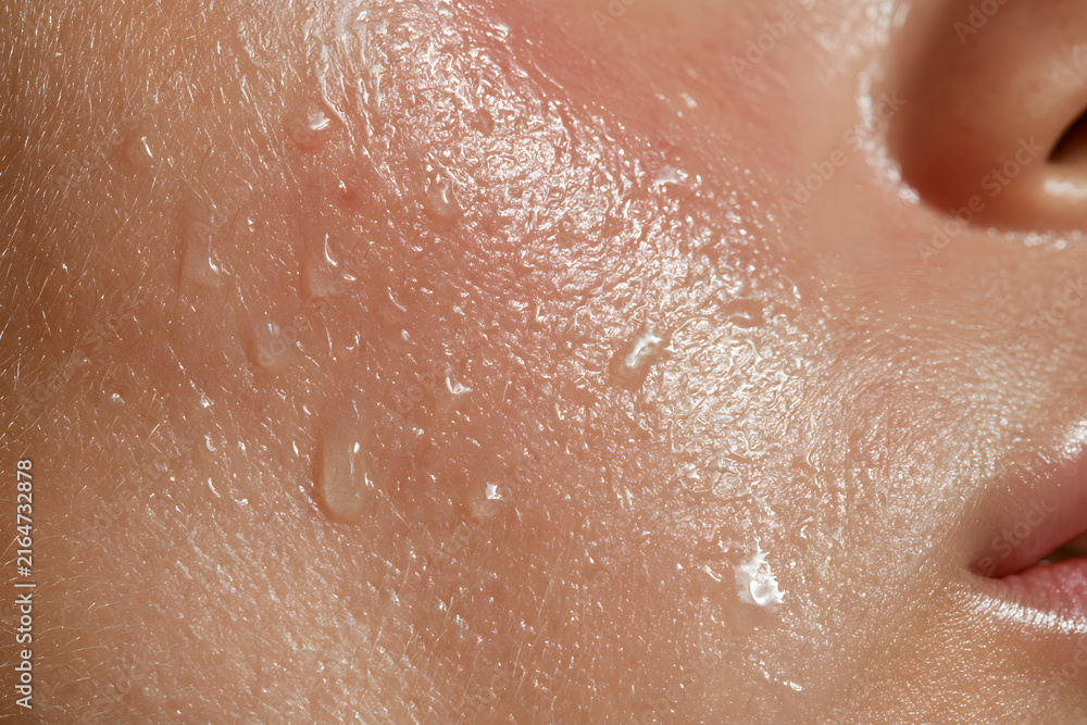 Fototapeta premium Skin Hydration Droplets Close Up on Cheek