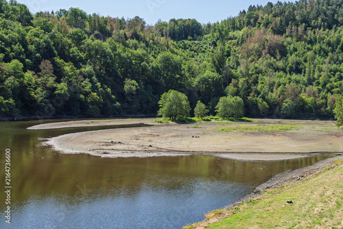 Low water level and exposed shoreline during summer drought in Germany